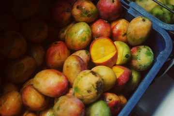 Closeup ripe  yellow oranage mangoes market box. Mangoes basket. Market in Sri Lanka