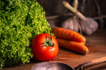Fresh organic vegetables on rustic wooden background