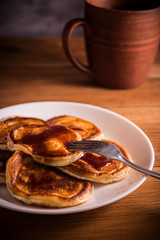 Fresh homemade pancakes on rustic wooden table
