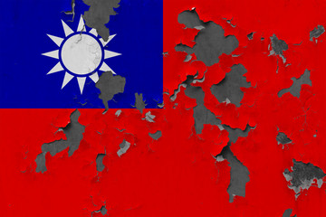 Close up grungy, damaged and weathered Taiwan flag on wall peeling off paint to see inside surface.