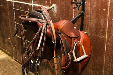 Leather bridle hanging on the back of the bow Jumping saddle, one set
