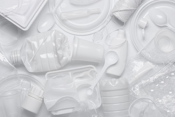 Plastic waste. Single-use plastic objects, ecological pollution. White packaging plastic products,...
