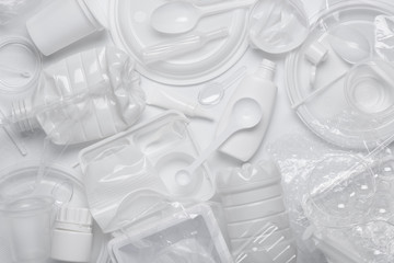 Plastic waste. White single-use plastic products garbage. Top view flat lay.