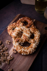 Pretzel with nuts, traditional homemade pastries on a dark background,