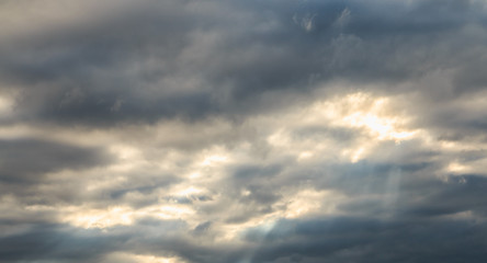 detailed view of a warm light crossing gray clouds