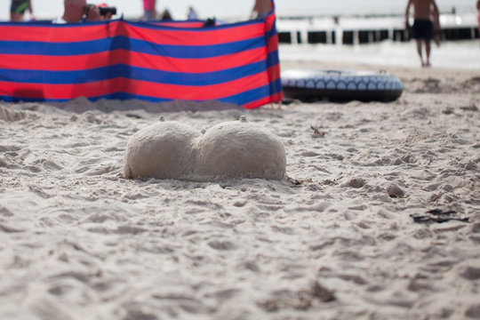 men's zipper on the sand, granny from the sand - two breasts with sand breasts