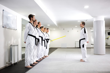 Martial art master lining up his taekwondo students