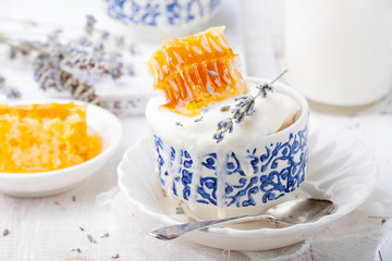 Ice cream with honey and lavender in bowls. White background.