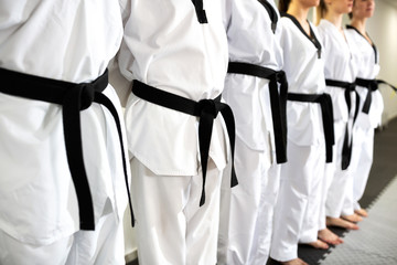Close up of lined up black belts