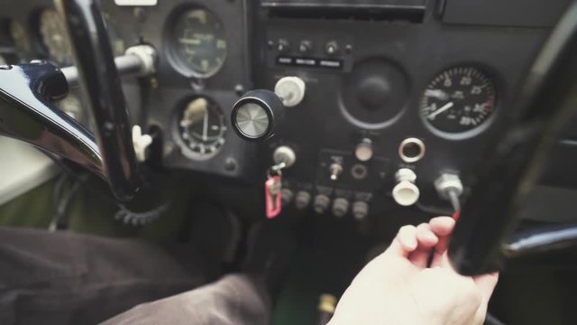 Pilot makes adjustments in some controls of an airplane