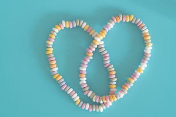 Beads and bracelets of sweets  candy on a turquoise background