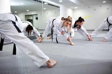 Foto op Aluminium Martial art taekwondo combat fighters stretching and warming up © didesign