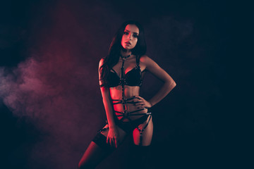 Fototapeta na wymiar Portrait of nice cool gorgeous adorable attractive sportive perfect thin fit form shape line wavy-haired lady wearing swordbelt teasing enjoying life isolated on black red light background