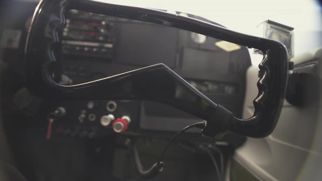 Close Up at the helm of a plane while a pilot places his hands