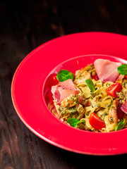 Pasta with shrimp and bacon. Dark wooden background. Restaurant menu