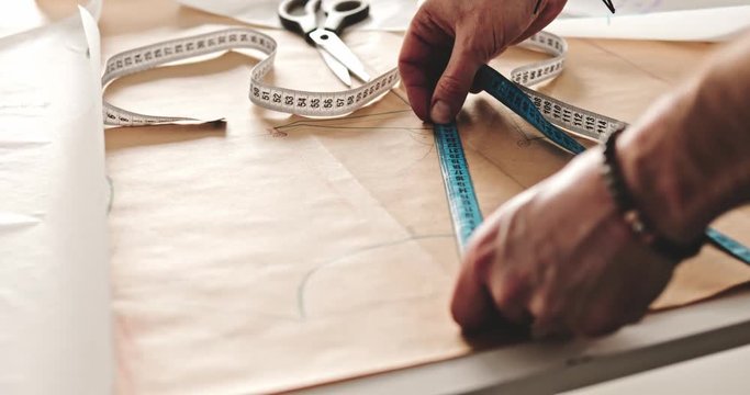 Tailor over work desk during work, fashion designer at workshop