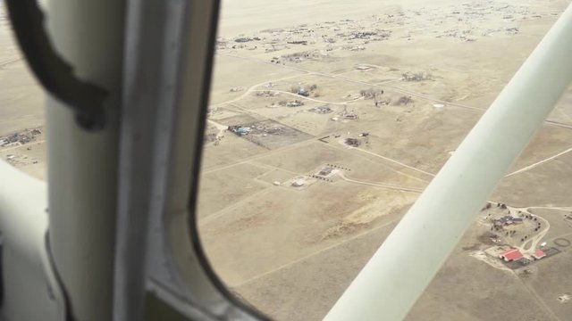 Arid rural area seen from inside the cockpit of a small plane