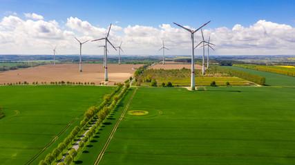 aerial view of landscape with wind turbines in the field