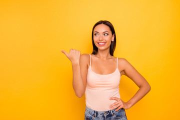 Close up photo beautiful amazing she her lady indicate hand arm side empty space wondered black friday low prices wear casual pastel tank-top outfit clothes isolated yellow bright vibrant background