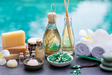 Spa and wellness massage setting. Still life with essential oil, salt and stones.