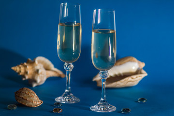 two glasses of champagne on red background