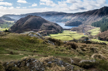 Fototapeta na wymiar English lake district. A distant view of Thirlmere from High Rigg with a mountainous backdrop on a sunny day.