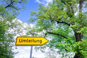 german road sign with text detour