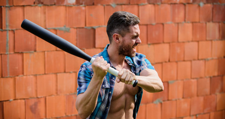 Man unshaven face muscular torso hold black baseball bat. Strong temper. Confident his strength....