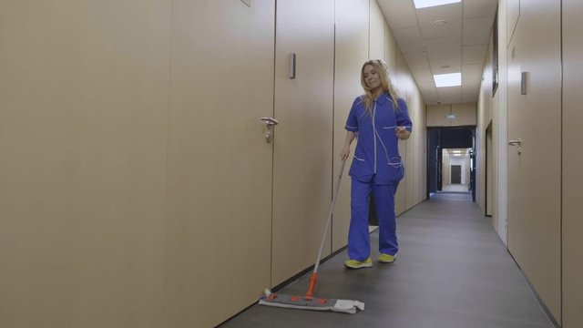 Happy cleaning service employee in headphones