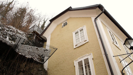 house near a rock face in Salzburg, winter time