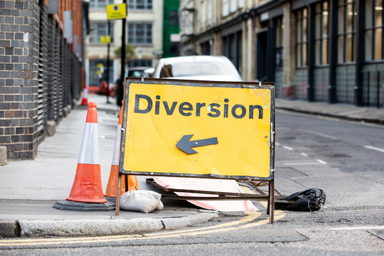 Yellow diversion road sign in a UK city street
