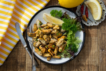 Peeled mussels with fresh lemom. Healthy seafood, natural sunlight, wooden rustic table.