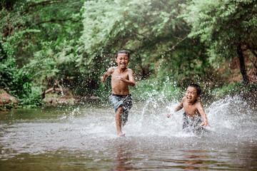 rural children playing water in the river