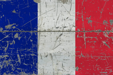 Grunge France flag on old scratched wooden surface. National vintage background.