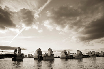 London River Thames Flood Barrier over dramatic cloudy sky.