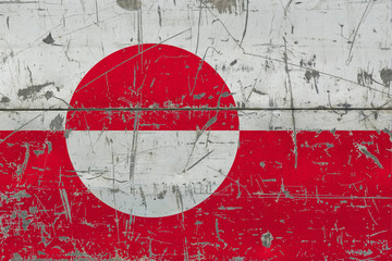 Grunge Greenland flag on old scratched wooden surface. National vintage background.