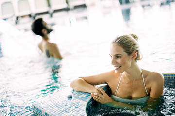 Portrait of beautiful woman relaxing in swimming pool