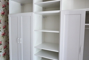 A large wardrobe is installed in the apartment. Internal details of the wardrobe.  Details and close-up.