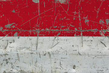 Grunge Indonesia flag on old scratched wooden surface. National vintage background.