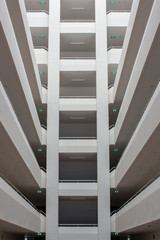 Modern building layers of floor structure. Abstract Tunnel corridor stack building with symmetry layer . Low angle view from the atrium of a high-rise residential tower of a public housing estate .