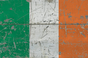 Grunge Ireland flag on old scratched wooden surface. National vintage background.