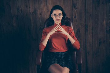 Obraz premium Close up photo of leader leadership lady enterprise owner sit leather furniture intelligent focused touch fingers wear stylish style trendy red sweater skirt checked brunette hair hairstyle interior