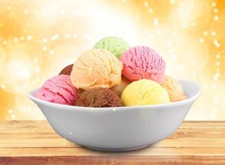 Ice cream scoops in bowl on white background