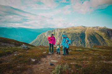 Obraz premium happy family with kids hiking in mountains