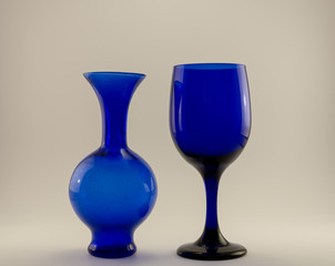 blue wine glass on blue vase on a white back ground