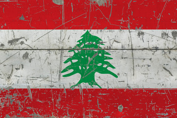 Grunge Lebanon flag on old scratched wooden surface. National vintage background.