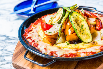 pasta farfalle, sausage and cheese in a frying pan
