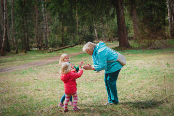 Fototapeta premium happy grandmother with kids play in nature