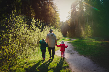 grandmother with kids walk in nature at sunset