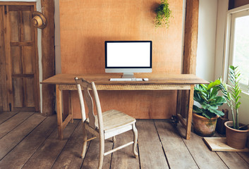 Blank Computer Monitor At Desk In home wood house Natural light